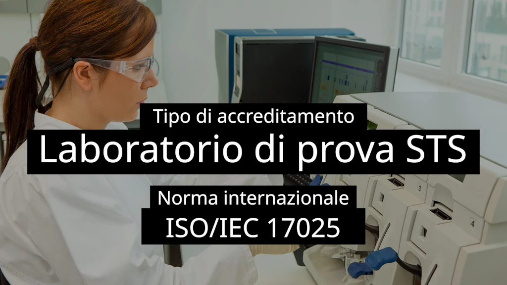 Una tecnico di laboratorio con occhiali protettivi al lavoro davanti a un analizzatore