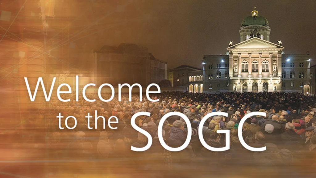 Text: ‘Welcome to the SOGC’. In the background, a crowd of people in front of the Federal Parliament Building.