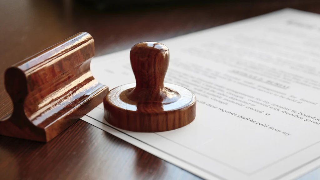 A wooden stamp is resting on a document.