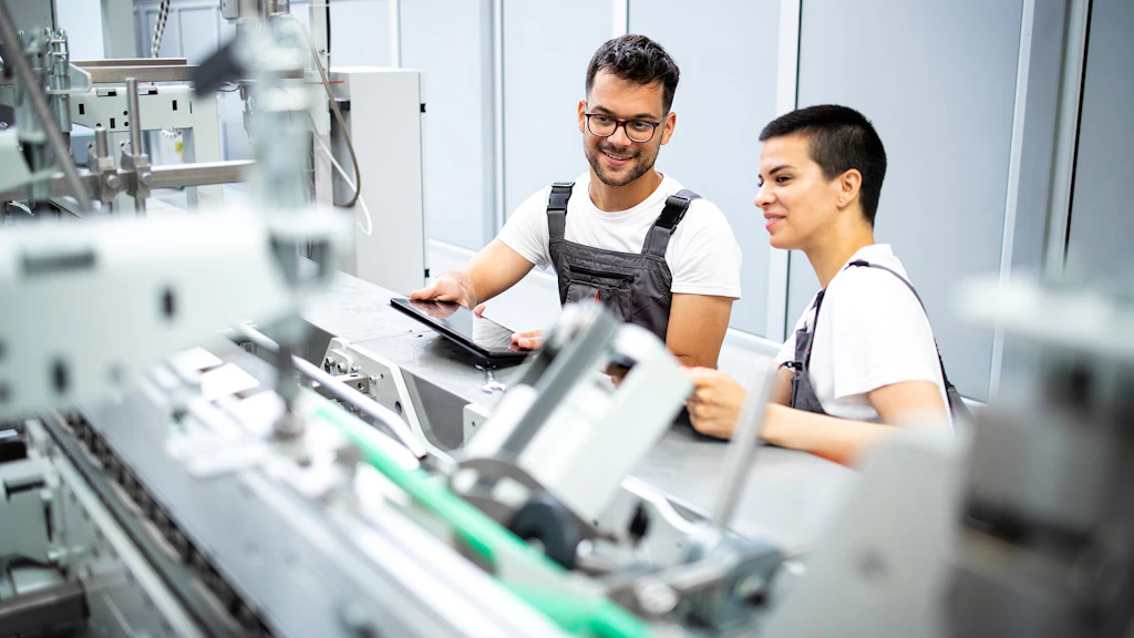 Experienced service engineers who maintain modern industrial manufacturing machinery at the production site